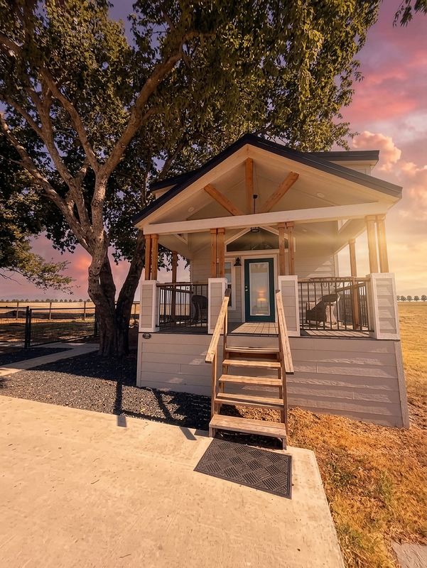 The Waxahachie Tiny Home at sunset with its covered front porch