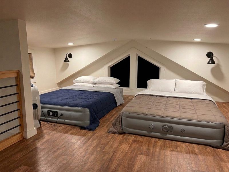 Sleeping loft with two queen air mattresses, room for a festival group at The Waxahachie Tiny Home